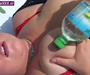 Lying in her bare tits and fat pussy, cools her nipples and hot horny bald pussy whiteh a cold bottle of water and masturbate her pussy.